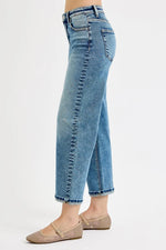 Blue jeans worn by a person on a white background