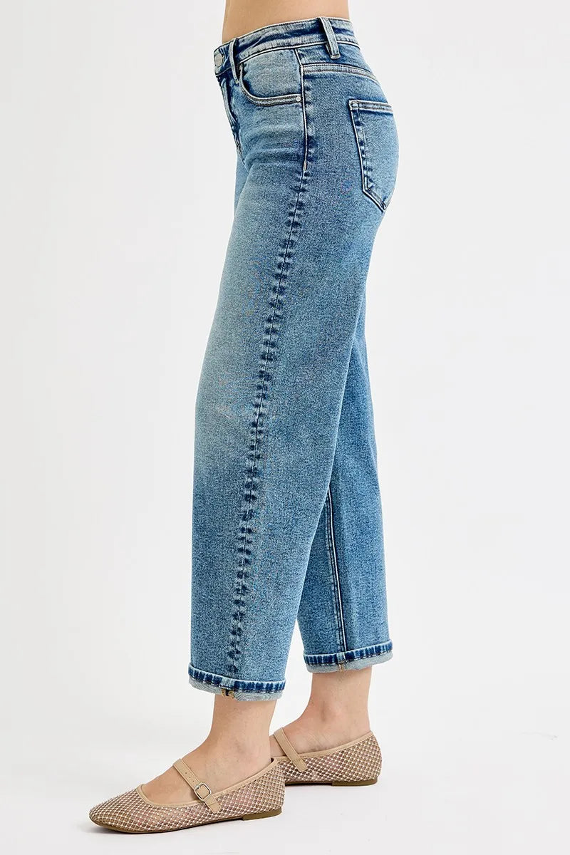 Blue jeans worn by a person on a white background