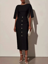 Black dress with button details worn by a model against a plain background