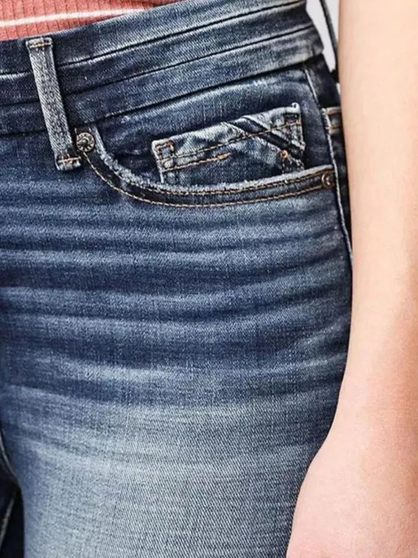 Close-up of blue jeans with a focus on the back pocket.