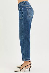 Blue jeans worn by a person on a white background
