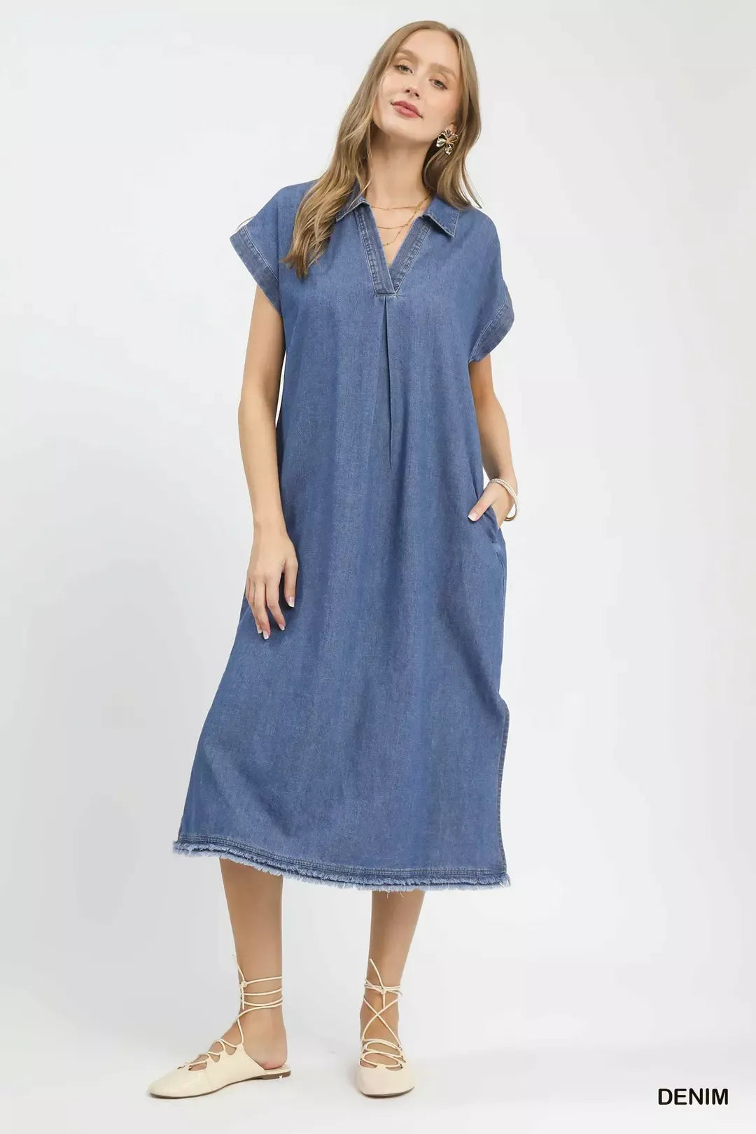 Woman wearing a denim dress on a white background