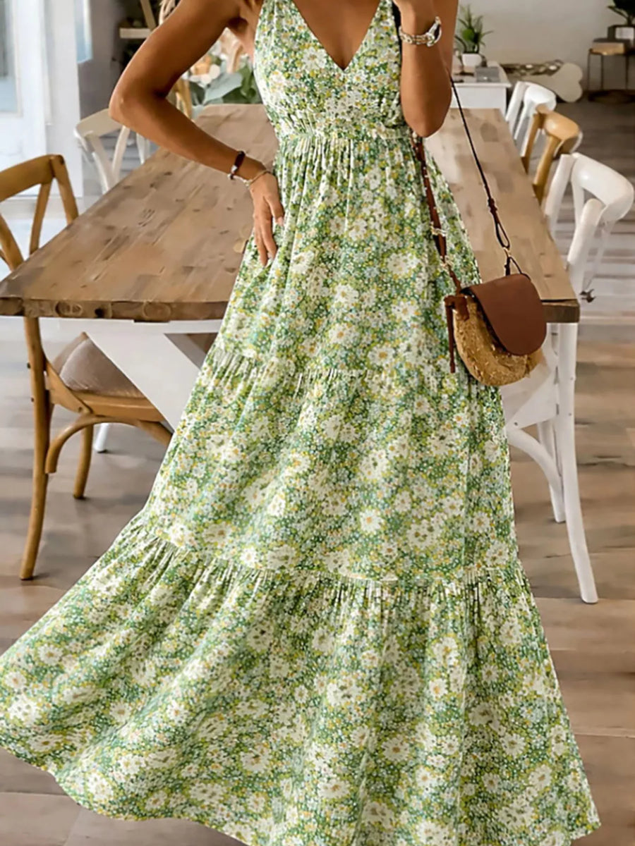 Woman wearing a green floral dress in a dining room setting