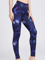 Galaxy-themed leggings worn by a person on a white background