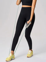 Person wearing black leggings and yellow shoes holding resistance bands on a light gray background