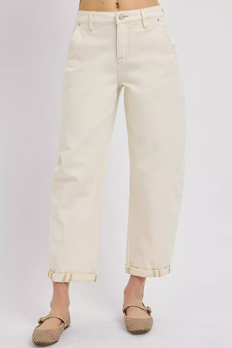 Beige jeans worn by a person on a light gray background
