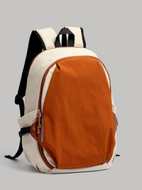 Backpack with orange front panel and beige sides on a gray background