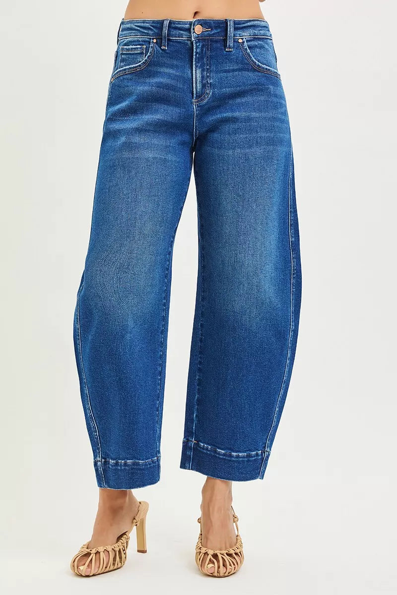Blue jeans worn by a person on a white background