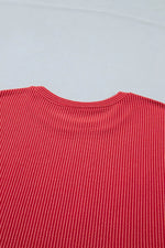 Close-up of a red textured fabric on a light gray background