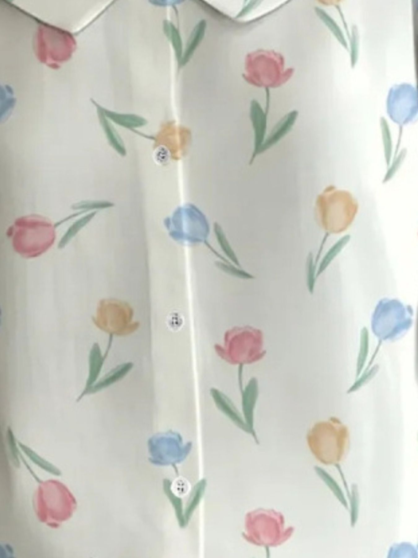 Floral patterned shirt with colorful tulips on a white background