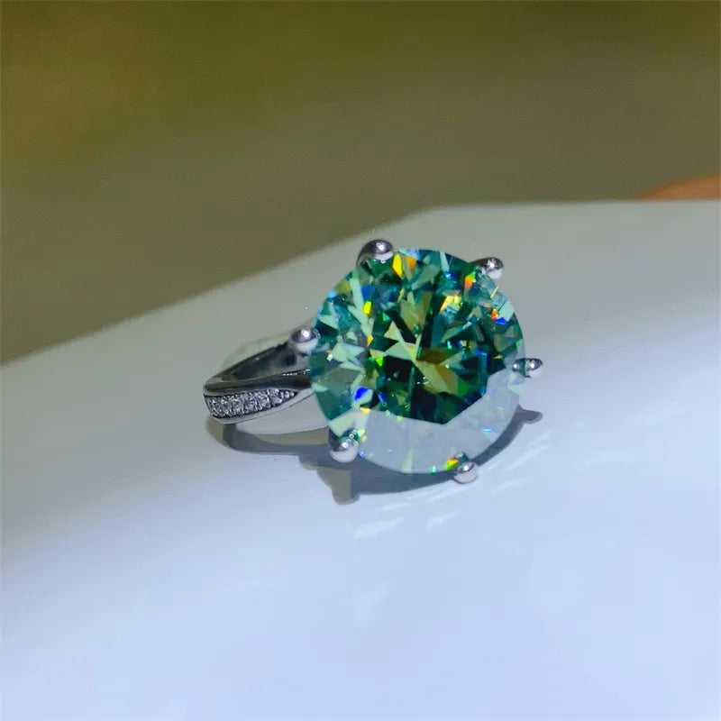 Ring with a large green gemstone on a white surface