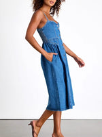 Woman wearing a blue denim dress on a white background