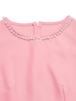 Pink dress with pearl embellishments on a white background