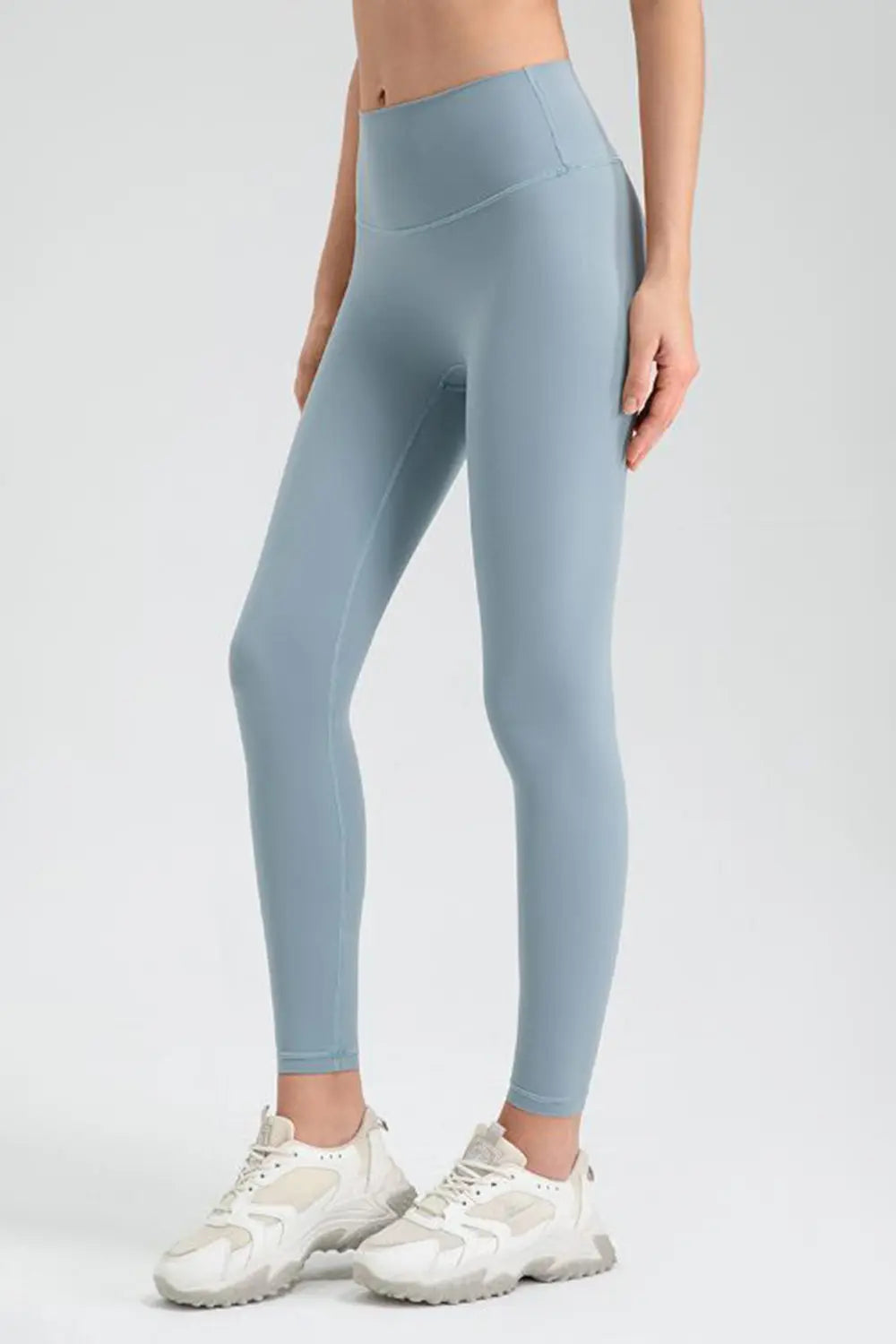 Light blue leggings worn by a person on a white background
