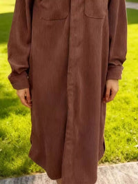 Brown long-sleeve shirt worn by a person on a grassy background