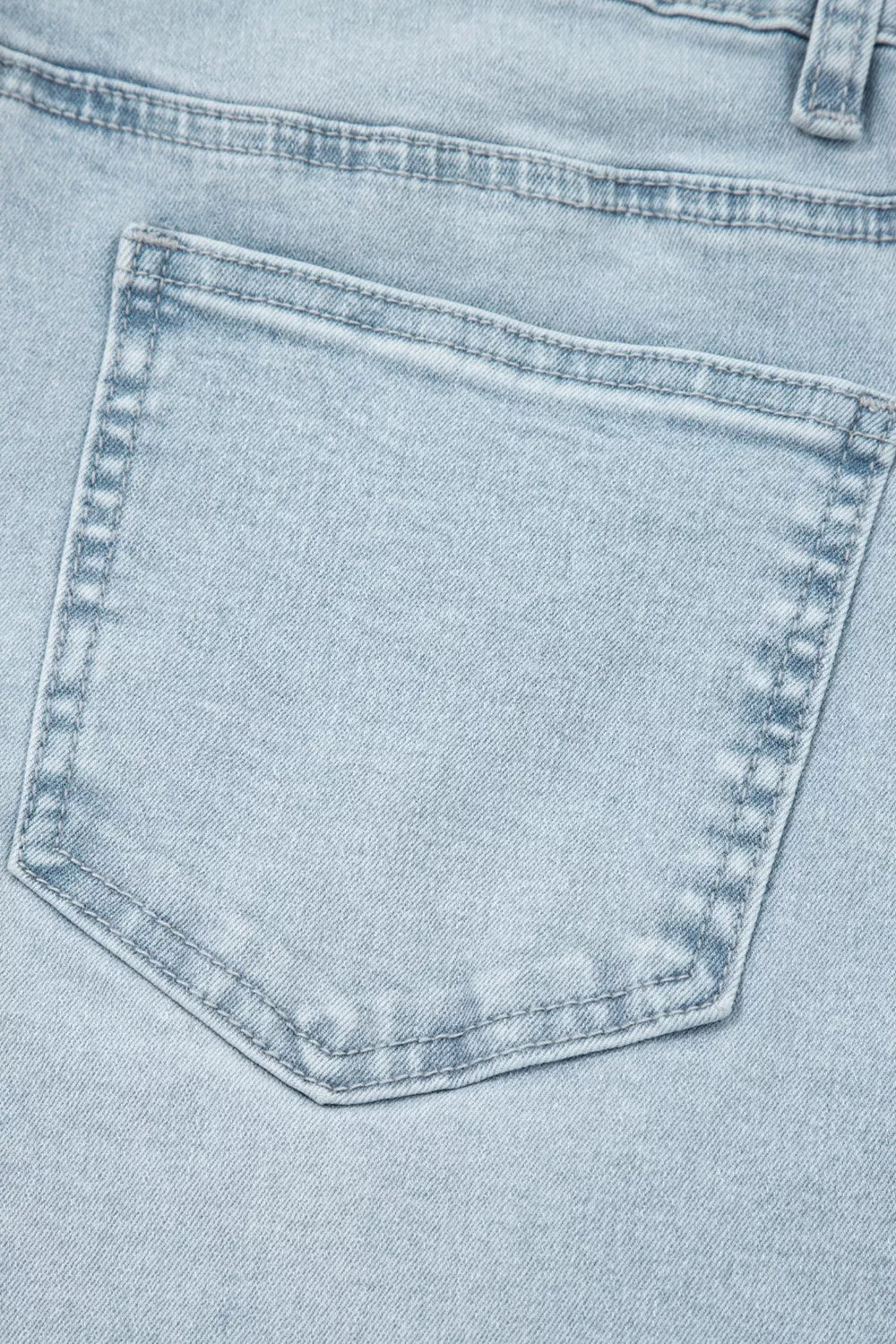 Close-up of a light blue denim pocket