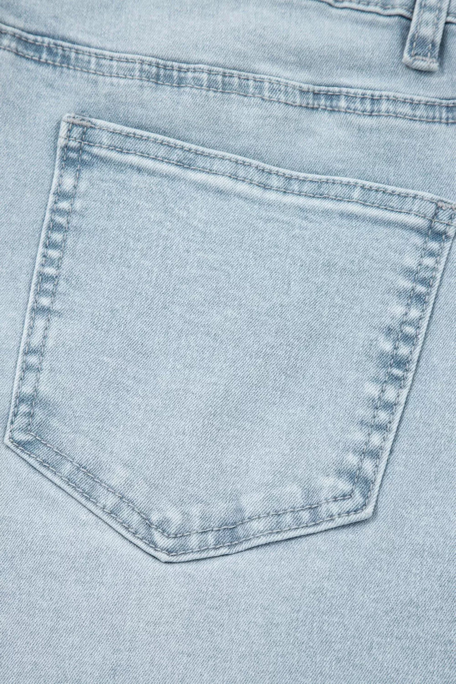 Close-up of a light blue denim pocket