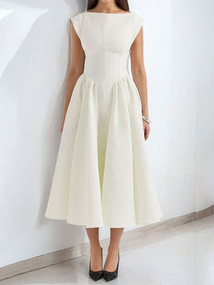 Woman wearing a white dress against a plain background