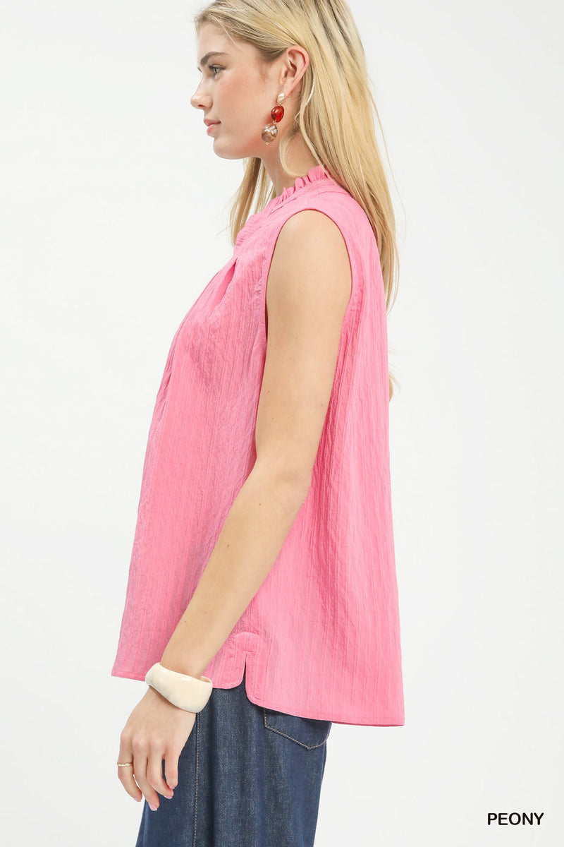 Woman wearing a pink sleeveless top with 'PEONY' branding on a white background