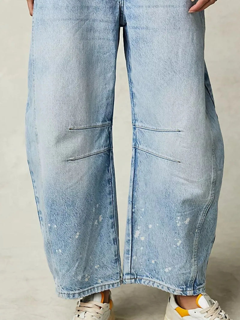 Light blue denim wide-leg jeans on a neutral background