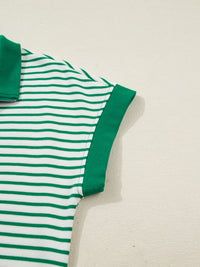 Green and white striped polo shirt on a beige background