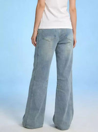 Light blue jeans worn by a person on a light blue background