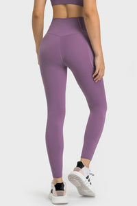 Purple leggings worn by a person on a white background