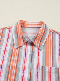 Striped shirt with orange, gray, and white pattern on a beige background