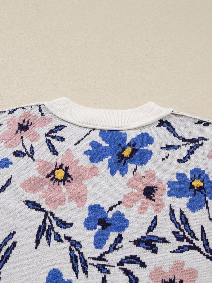 Floral patterned fabric with blue and pink flowers on a beige background