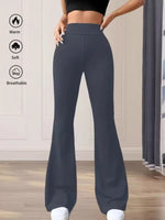 Dark gray flared pants worn by a person indoors with text icons indicating warmth, softness, and breathability.