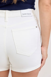 White shorts with 'Judy Blue' branding on a white background