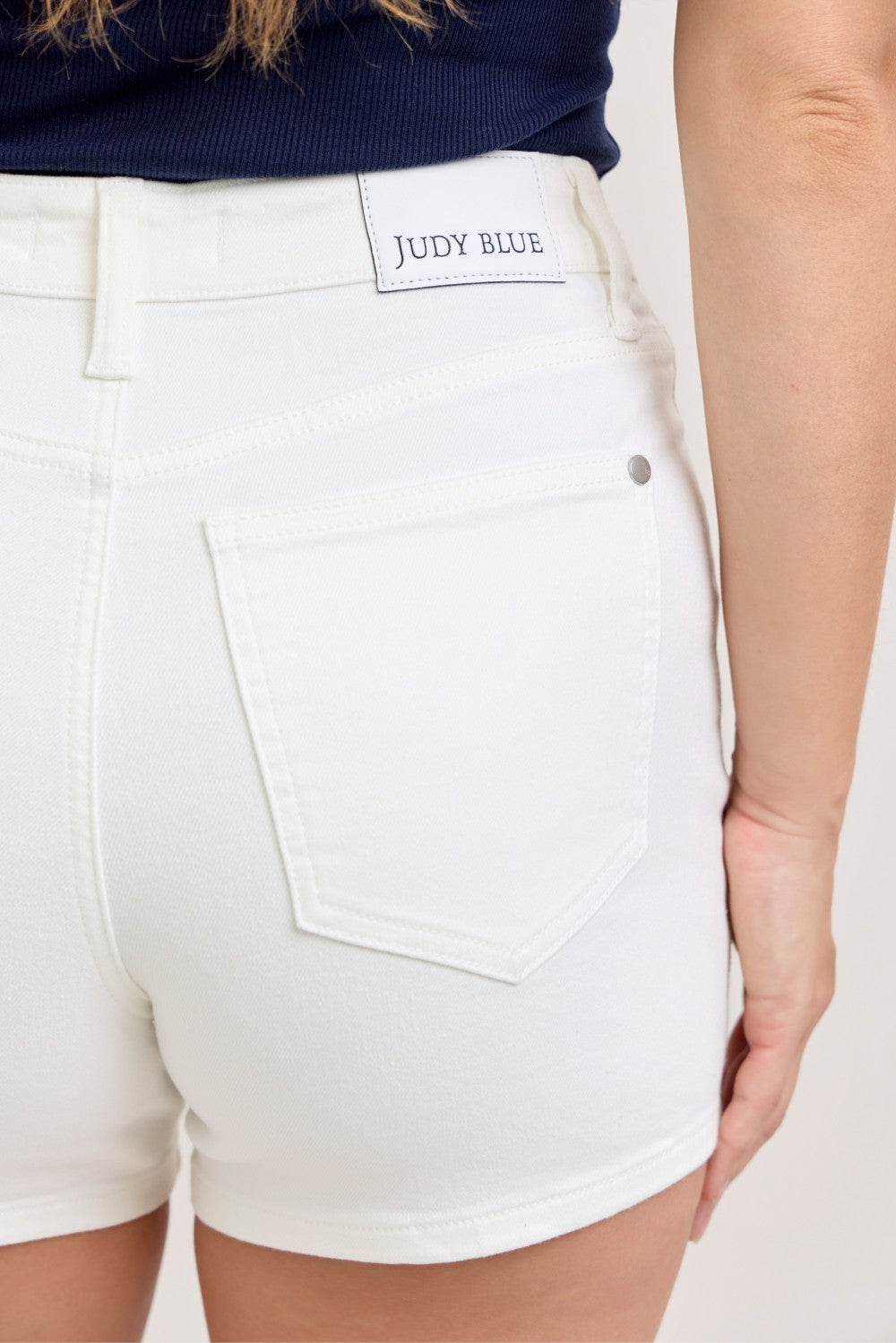 White shorts with 'Judy Blue' branding on a white background