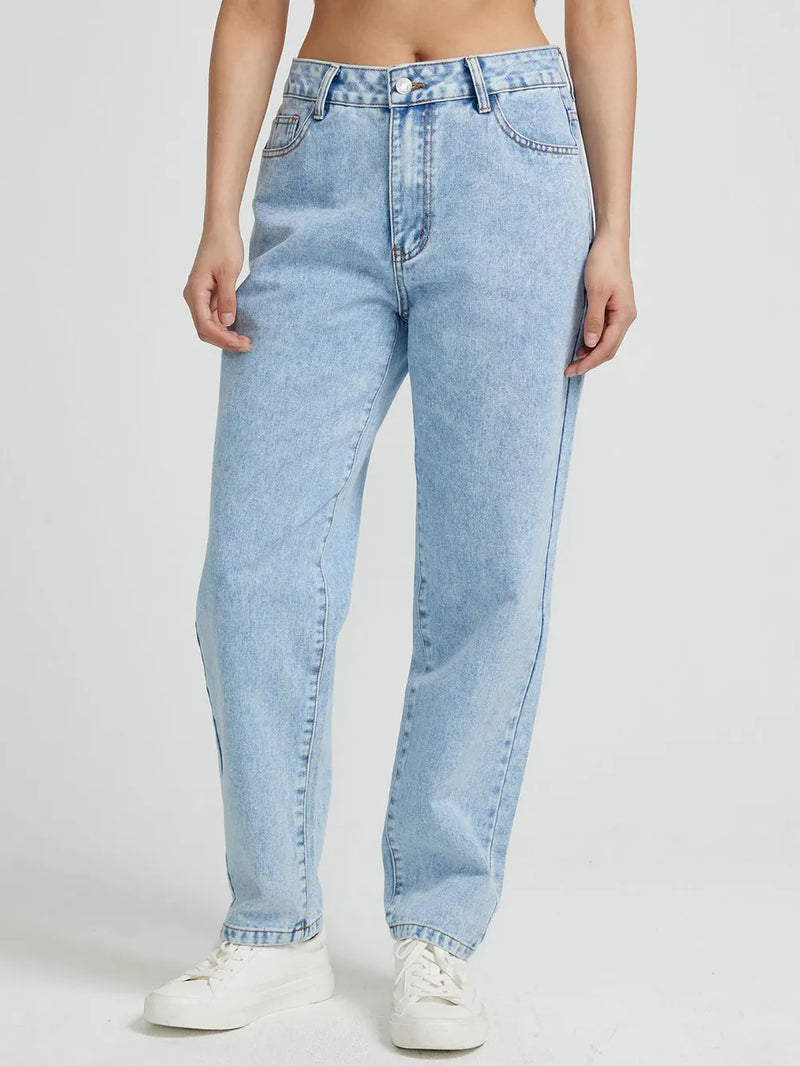 Light blue jeans worn by a person on a white background