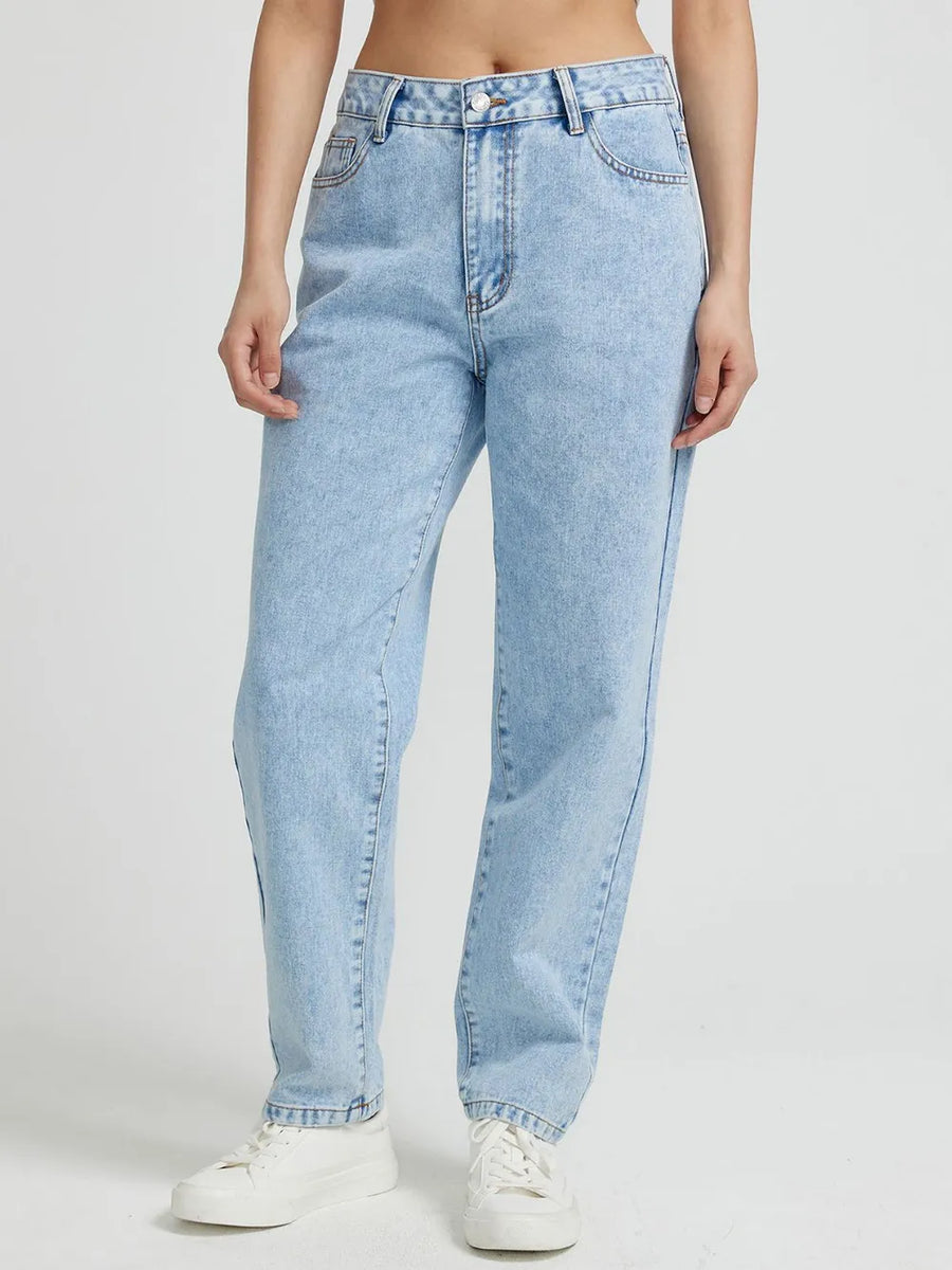 Light blue jeans worn by a person on a white background