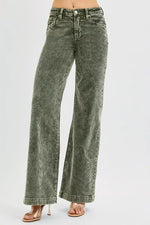 Green acid-wash jeans on a white background