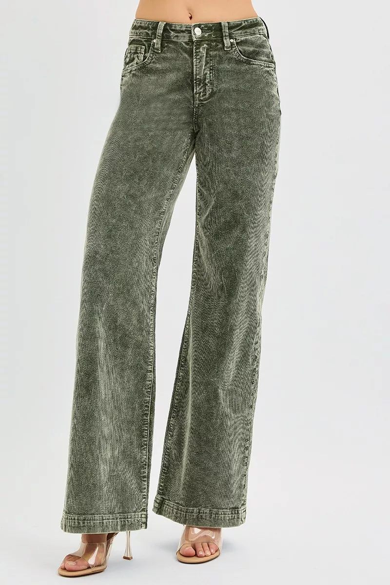 Green acid-wash jeans on a white background