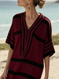 Close up of woman wearing a burgundy and black striped dress
