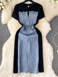 Black t-shirt with denim dress overlay on a textured white surface