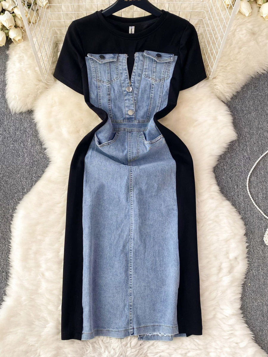 Black t-shirt with denim dress overlay on a textured white surface