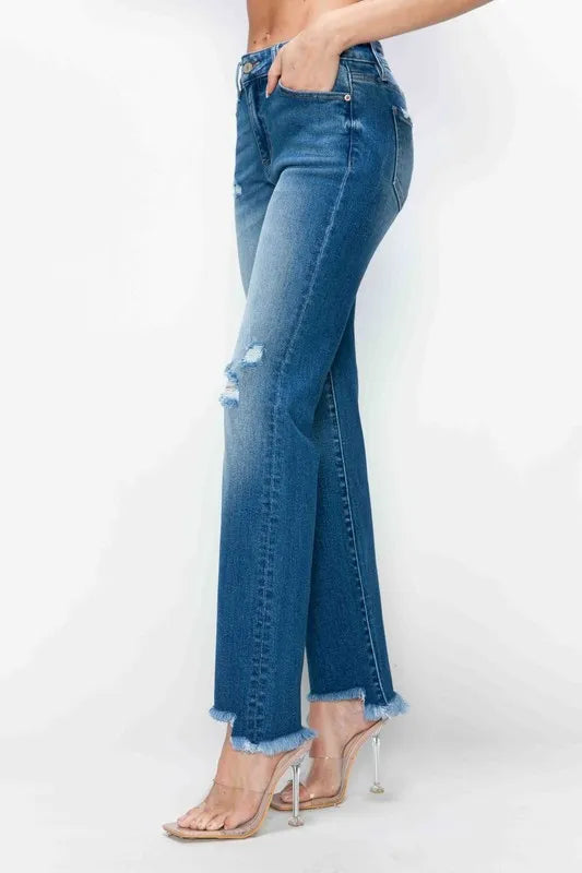 Blue jeans worn by a person on a white background