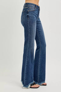 Blue jeans with a frayed hem on a white background