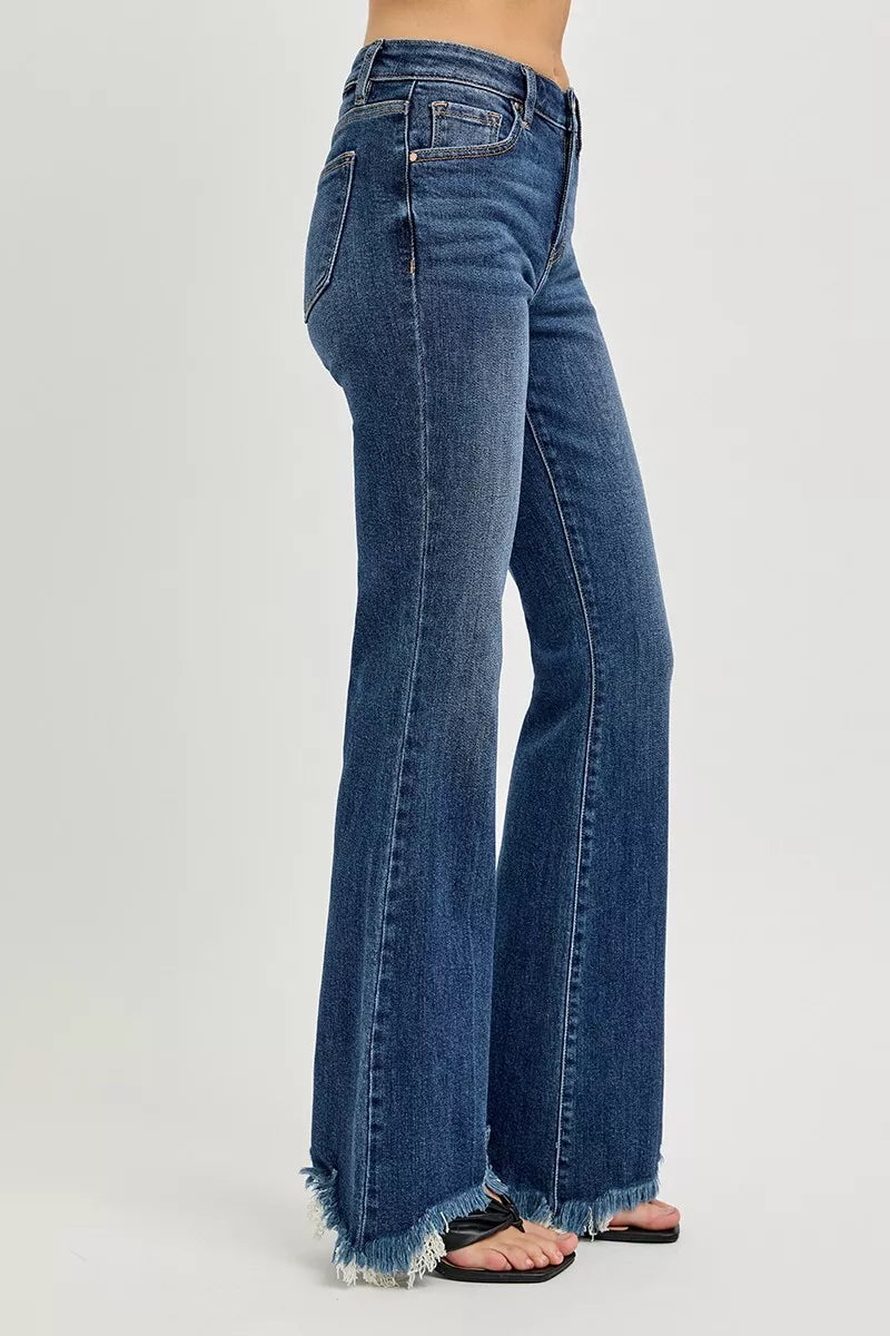 Blue jeans with a frayed hem on a white background
