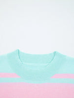Light blue and pink sweater on a white background