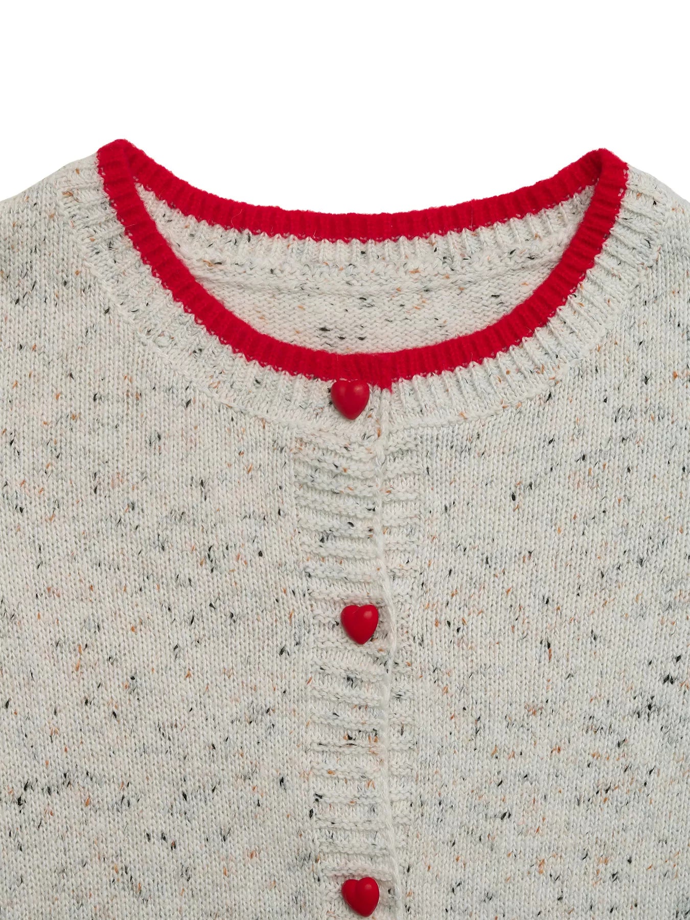 Close-up of a textured sweater with red trim and buttons on a white background