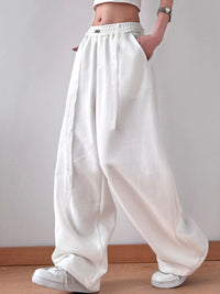 White wide-leg pants worn by a person on a plain background