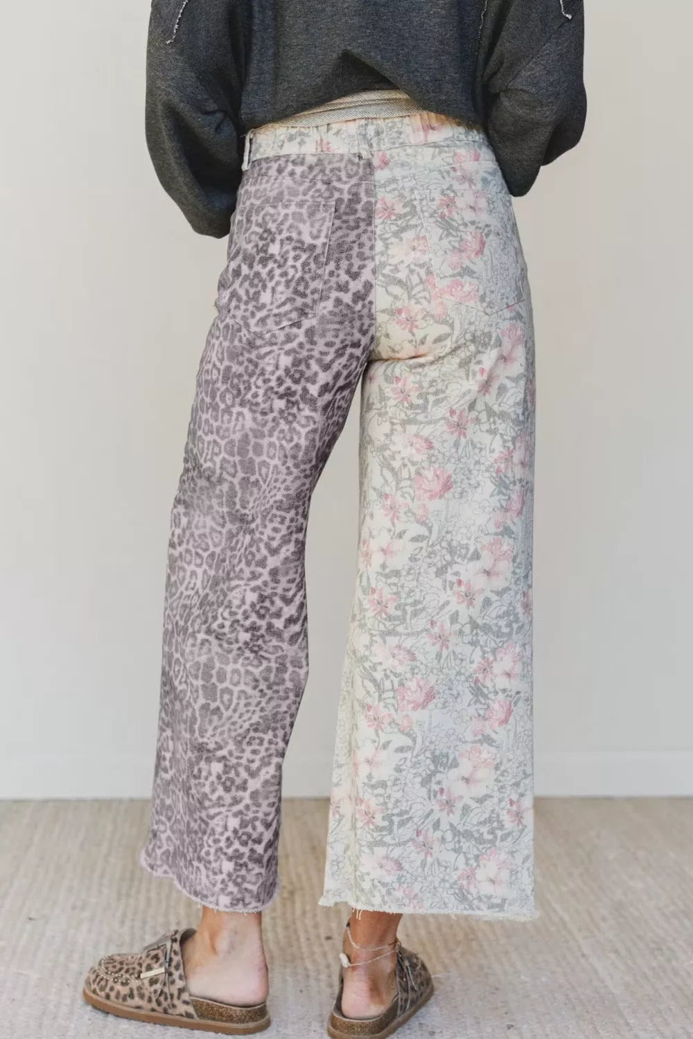 Person wearing patterned pants with a plain background