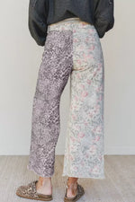 Person wearing patterned pants with a plain background