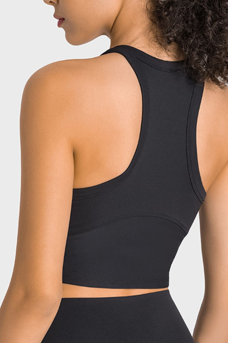 Black sports bra worn by a person on a light gray background