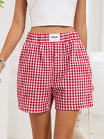 Red and white checkered shorts with a visible brand label on a plain background