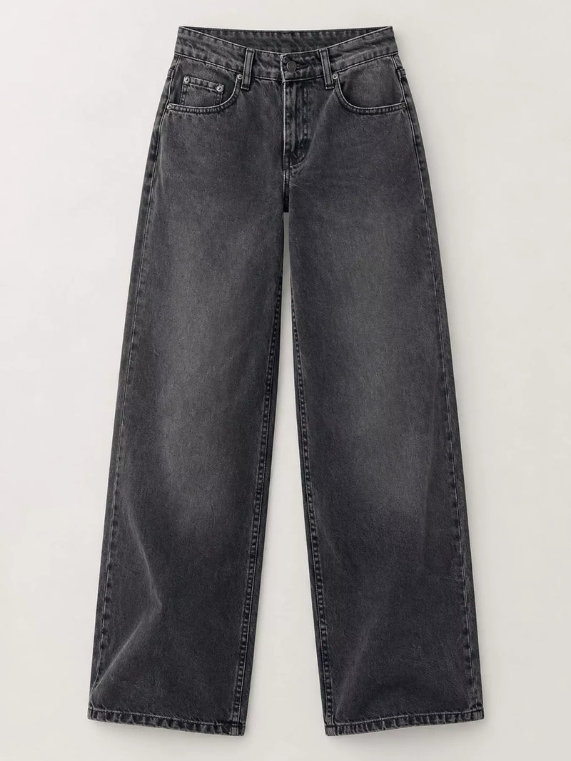 A pair of wide-leg jeans in a washed charcoal gray denim, displayed flat against a light off-white background.